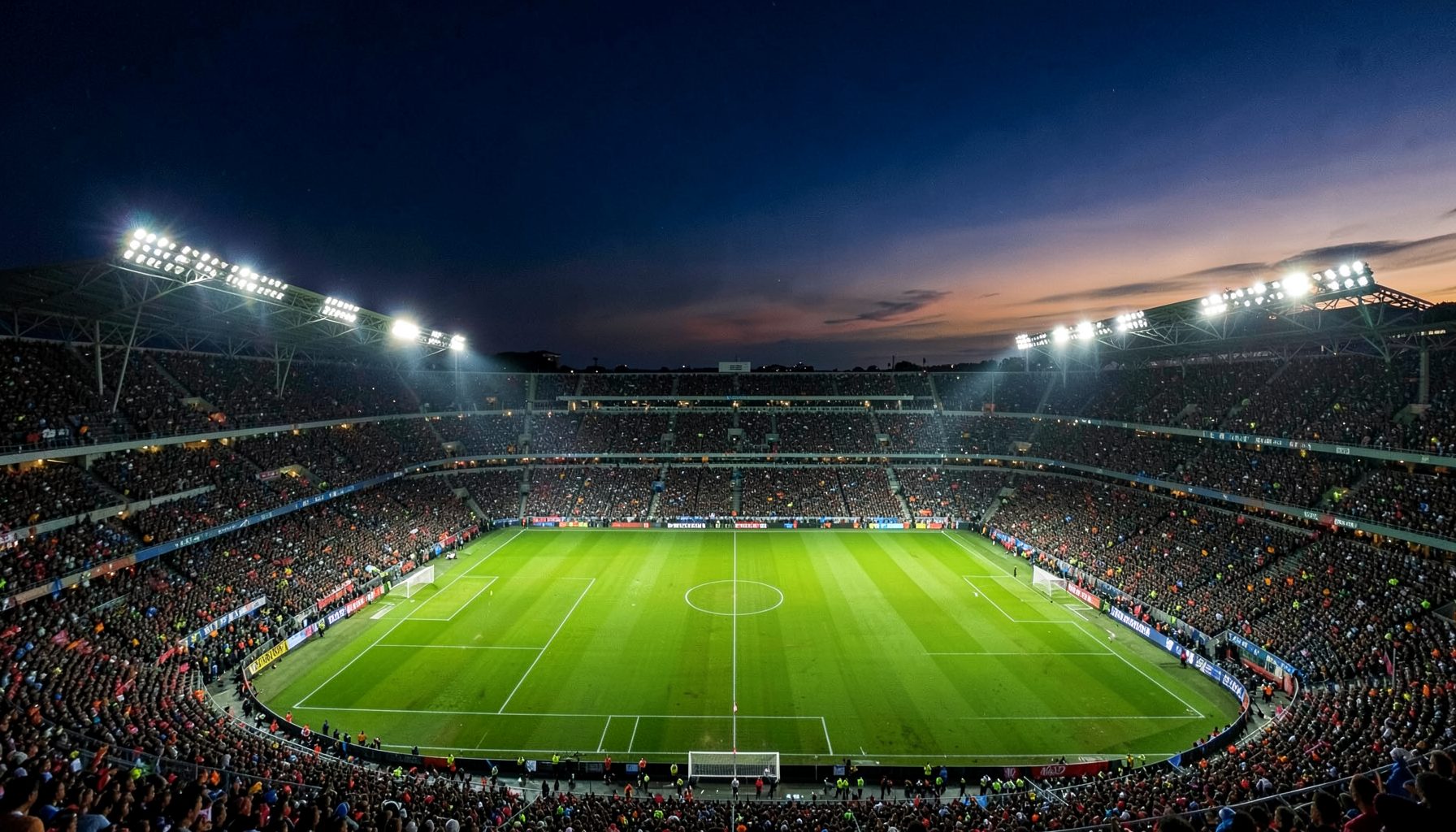 A dramatic aerial view of a packed Italian football stadium at dusk, floodlights blazing across the green pitch, deep navy sky with hints of amber and gold