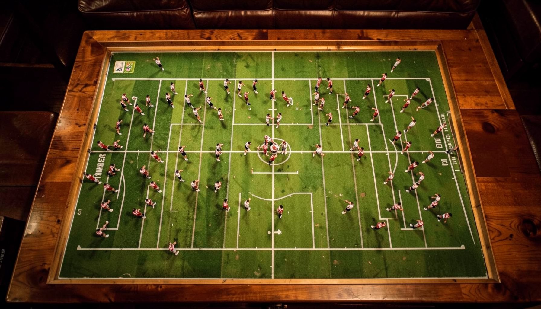 Aerial view of a football formation on a tactics board, warm indoor lighting, rich wood tones